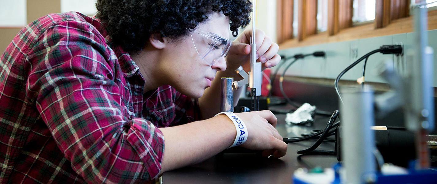 male student in science lab