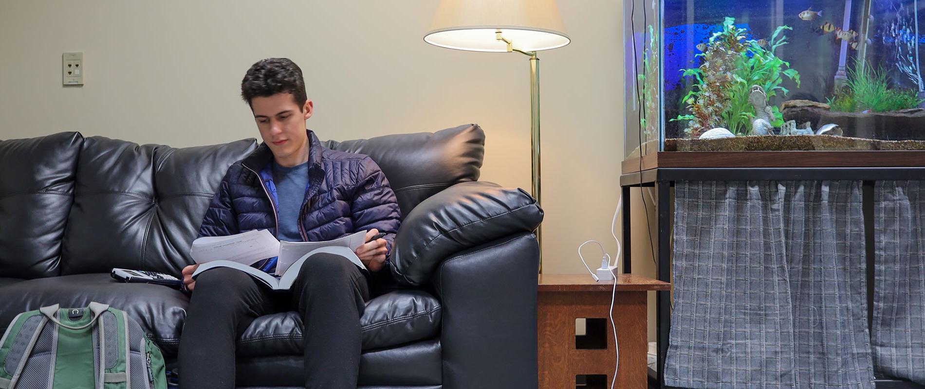 student on couch studying